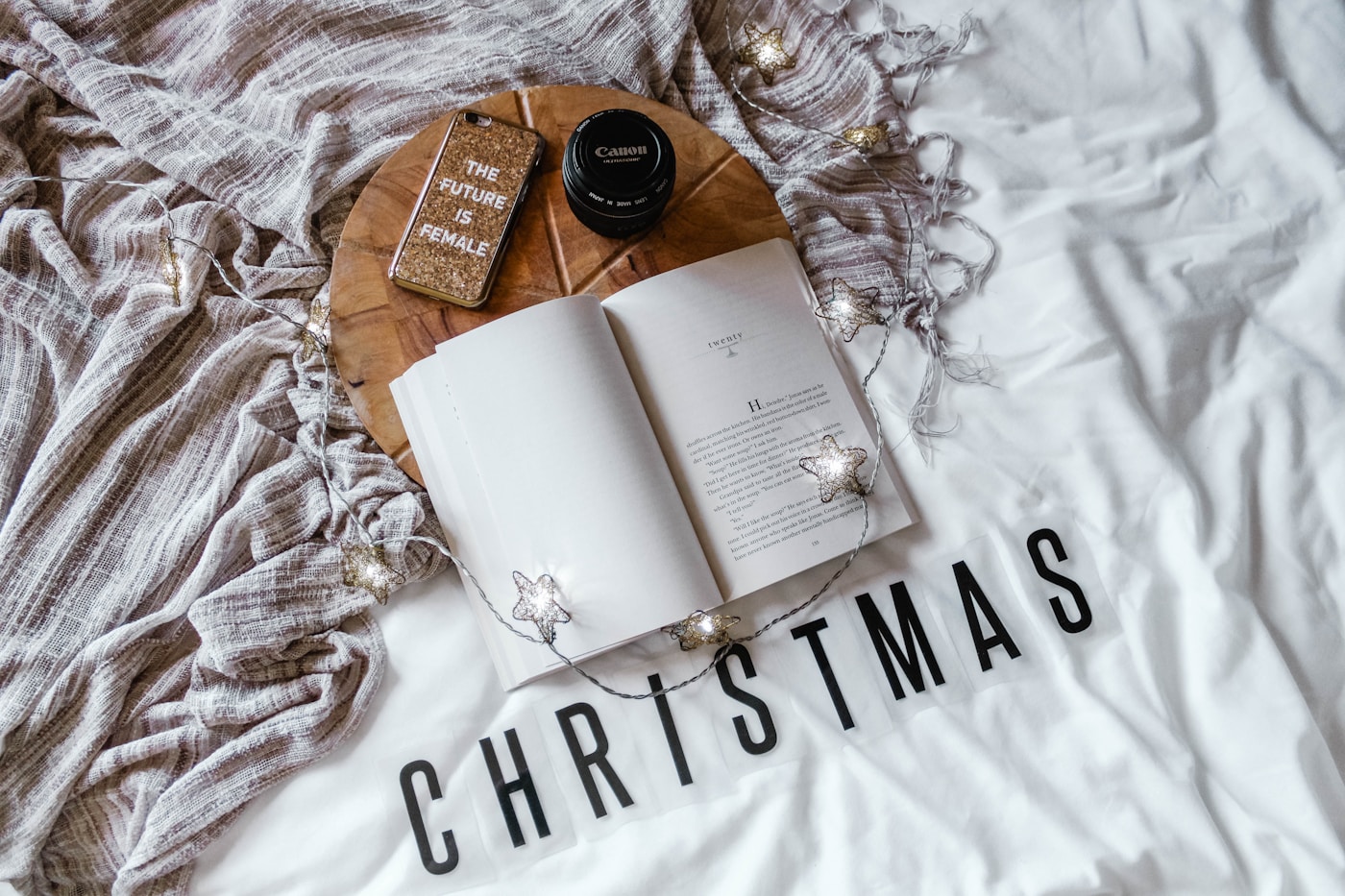 Person writing a Christmas wishlist at a cozy desk